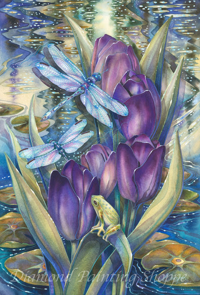 Diamond painting kit artwork featuring two iridescent dragonflies, a small frog, and vivid purple tulips beside a sparkling, lily-filled pond under magical evening light.

